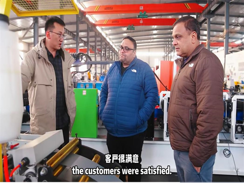 American clients inspecting garage door roll forming equipment at Zhongtuo
